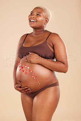 Buy stock photo Pregnant, black woman and smile with flowers on belly in studio for body, baby wellness and ivf healthcare. Mother, pregnancy and floral plants on stomach with happiness, beauty or natural childbirth