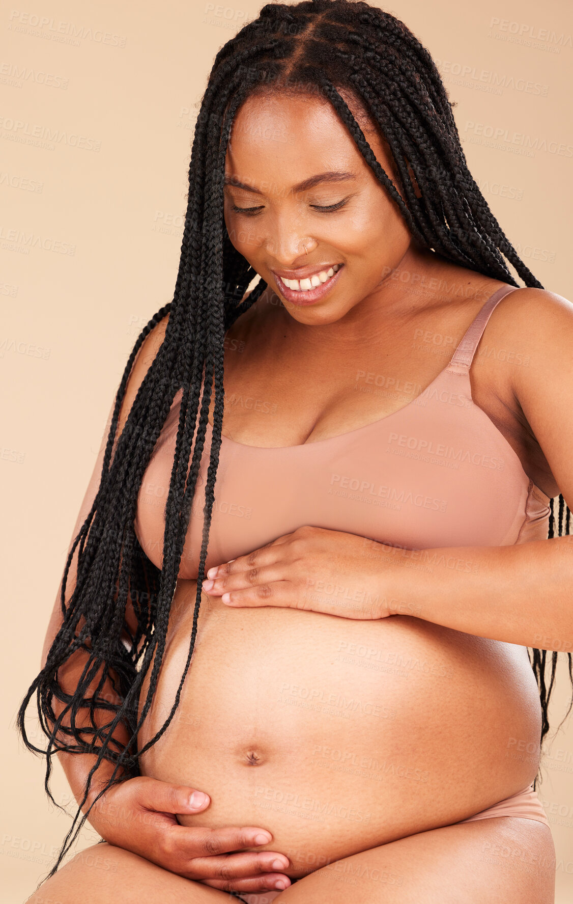 Buy stock photo Pregnancy feeling, lingerie or relax woman with studio smile, happy and excited for baby, stomach growth or motherhood. Gynecology, maternity or pregnant African model with healthcare, love and hope