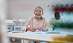 Education, learning and portrait of child with smile in classroom for reading, writing and math in Montessori school. Books, students and happy girl at desk with fun notebook studying for future exam