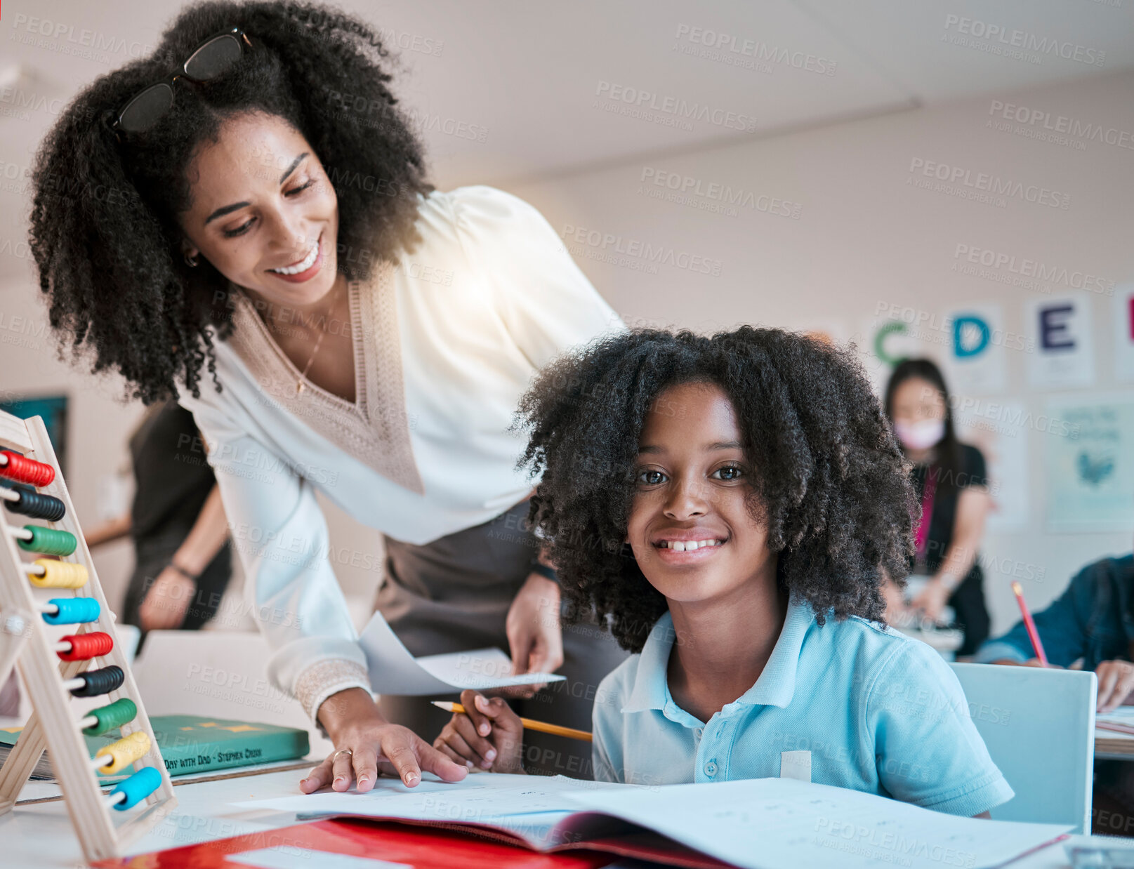 Buy stock photo Young child learning maths, happy teacher in classroom with children and knowledge at desk. Female educator writing in workbook, reading kids notebook at school and teaching student with assignment