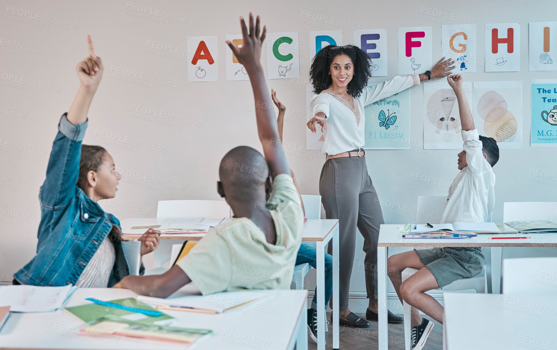 Buy stock photo Question, learning and education at school with kids hands raised to answer alphabet assessment. Classroom, learners and tutor teaching a summary information in a class with smart and clever group