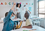 Teacher or woman happy for education and teaching at school with kids learning the alphabet and answer a question. Raised hands, learners and tutor helping a clever and smart classroom
