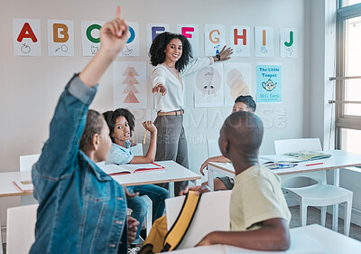 Buy stock photo Teacher, classroom and education at school with children learning the alphabet and answer a question. Raised hands, learners and tutor teaching for child development in a class with smart kids
