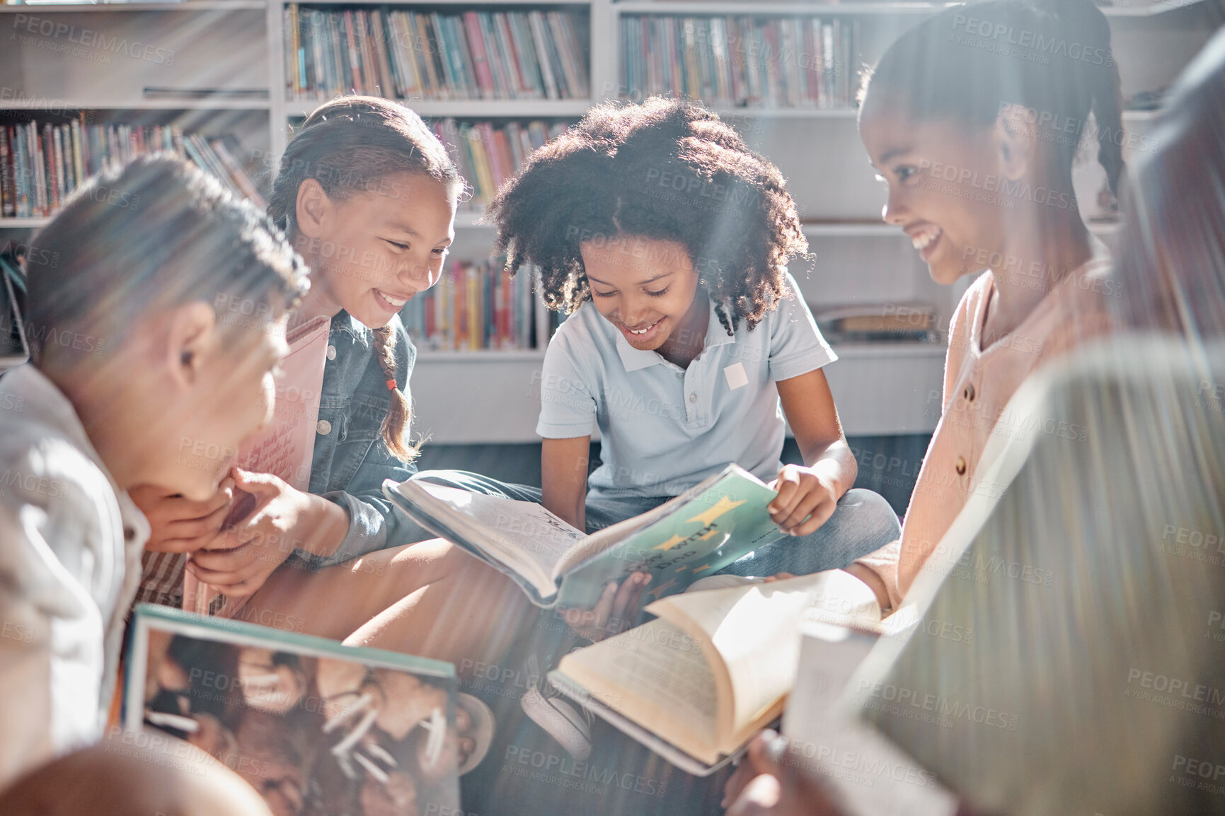 Buy stock photo Education, books or students reading in a library for group learning development or growth. Storytelling, kids or happy children talking together for knowledge on funny fantasy stories at school
