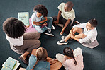 Teacher, storytelling or kids on classroom floor or library for learning development growth, reading skills. Top view, group or students listening to a black woman reading fun fantasy books at school