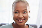 Smile, happy and portrait of a black woman in a house to relax, rest and calm. Beautiful, attractive and face of a cheerful African girl smiling, relaxing and elegant in the living room of home