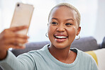 Black woman, influencer and smile for selfie, social media or profile picture relaxing on living room sofa at home. African American female vlogger smiling in happiness for online post in the lounge