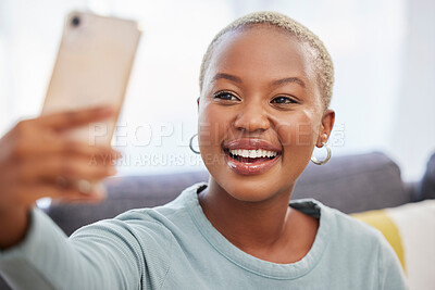 Buy stock photo Black woman, influencer and smile for selfie, social media or profile picture relaxing on living room sofa at home. African American female vlogger smiling in happiness for online post in the lounge