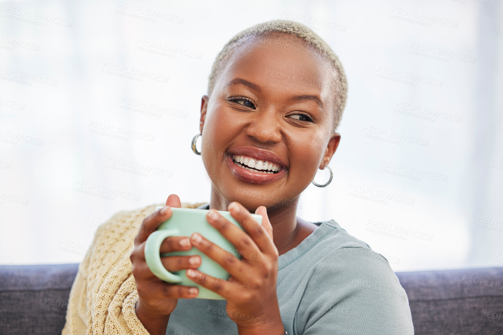 Buy stock photo Black woman, relax and sofa with drink, coffee and smile in home living room for me time. Young African lady, peace or tea on couch for happiness, self care and chilling in house, apartment or room