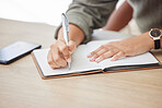 Woman hands, writing and notebook for planning schedule, agenda or list with a pen on an office table. Book, planner or journal with creative ideas, strategy or goals as inspiration for writer person