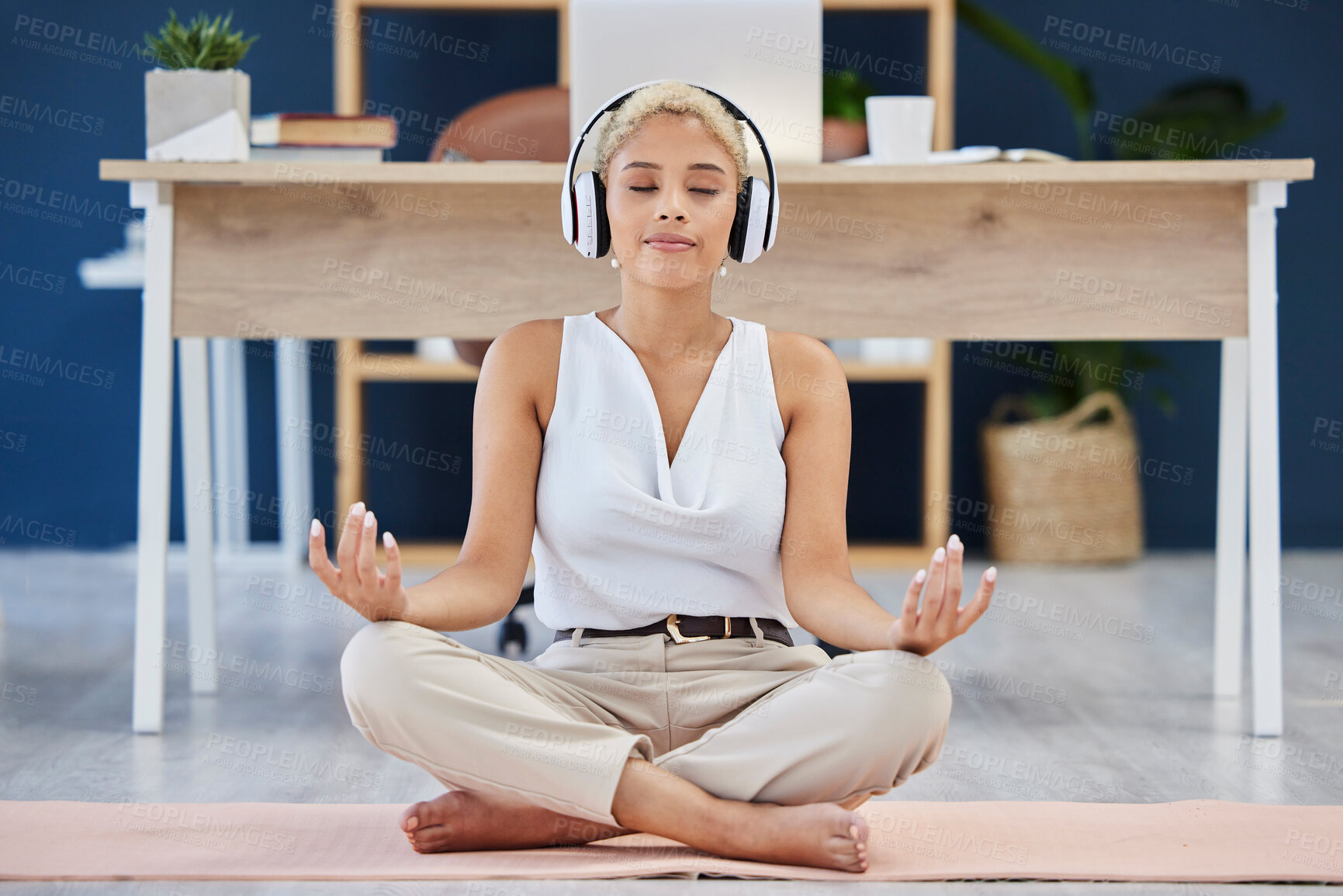 Buy stock photo Music, meditation and yoga with a business black woman finding inner peace or zen in her office. Headphones, mental health and balance with a calm female eployee meditating at work for wellness