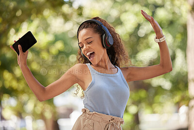 Buy stock photo Phone, music and dance with a black woman listening to the radio in the park during summer while feeling free. Freedom, sing and dancing with an attractive young female streaing audio in a garden