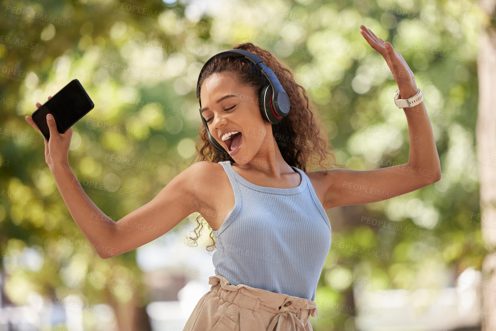 Buy stock photo Phone, music and dance with a black woman listening to the radio in the park during summer while feeling free. Freedom, sing and dancing with an attractive young female streaing audio in a garden