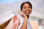 Shopping bag, black woman and smile portrait outdoor with retail bags after sale and sales promotion. Happy, customer and excited young person in nature feeling freedom after deal and mall discount