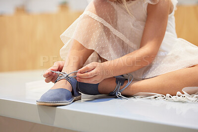 Buy stock photo Hands, little girl and tying shoe lace on table getting ready for walk, travel or shopping at home. Hand of child, kid or toddler trying to tie shoes in preparation for traveling, walking or outing