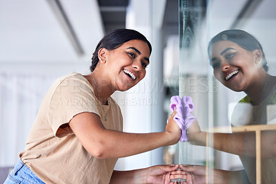 Buy stock photo Happy, girl and reflection cleaning window with household cloth and satisfied smile for shiny transparent surface. Happiness, focus and concentration of young Indian woman polishing glass in house. 