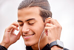 Closeup, fitness and outdoor with earphones, motivation and workout for wellness, healthy lifestyle and music. Zoom, male and athlete with headphones, smile and podcast with exercise and determined