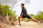 Stretching legs, running and man on nature trail for fitness, marathon training and cardio workout outdoors. Sports, body performance and happy male athlete warm up for wellness, exercise and balance