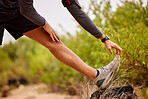 Running, stretching legs and man on nature trail for fitness, marathon training and cardio workout. Sports mockup, healthy body and shoes of male runner warm up for wellness, exercise and performance