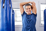 Portrait, fitness and stretching with a boxing man in a gym getting ready for a workout for health. Exercise, smile and warm up with a happy male boxer training as a fighter in a performance center