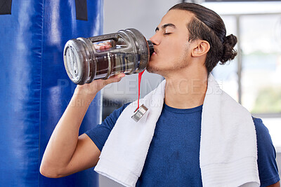 Buy stock photo Fitness, man and drinking water in gym for health, rest and energy for boxing, workout and towel. Thirsty sports person, bodybuilder and athlete hydration, bottle and exercise nutrition for wellness