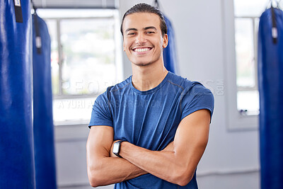Buy stock photo Personal trainer man, gym portrait and arms crossed with focus, wellness and health in workplace. Happy coach, smartwatch and strong mindset for exercise, mma and boxing training in workout studio