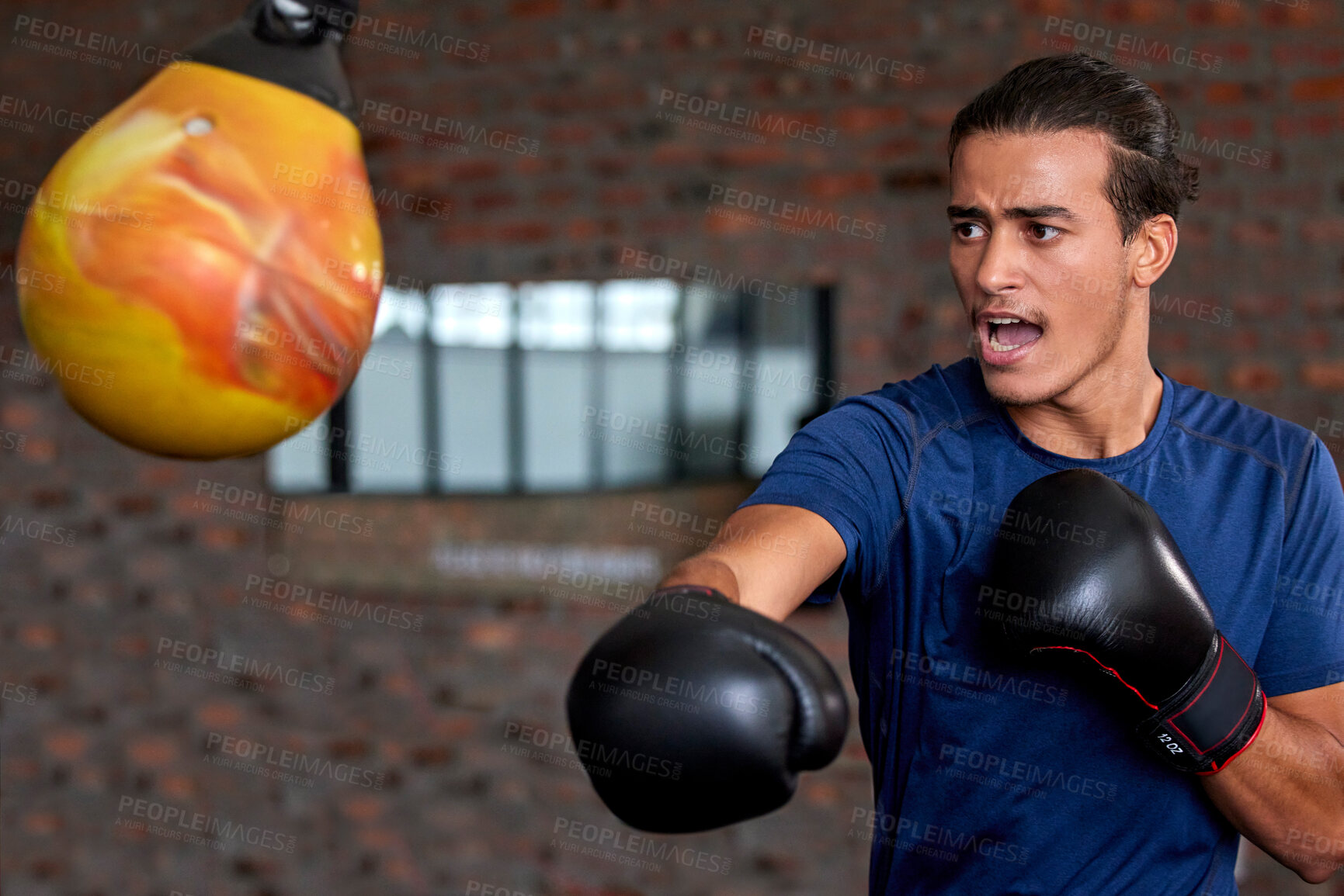 Buy stock photo Gym fitness and boxer man punch for sports workout, training and athlete practice with equipment. Energy, focus and power of young martial arts fighter guy at kickboxing and wellness club.