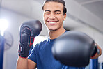 Fitness, portrait or happy boxer in training, cardio workout or exercise in a sports gym or health club. Face, man or healthy fighter in boxing gloves exercising with motivation, focus or goals 