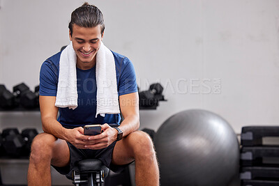 Buy stock photo Fitness, phone or man on social media to relax at gym in training, workout or exercise resting on a break. Tired, happy or healthy sports athlete typing text on a bench and exercising for body goals