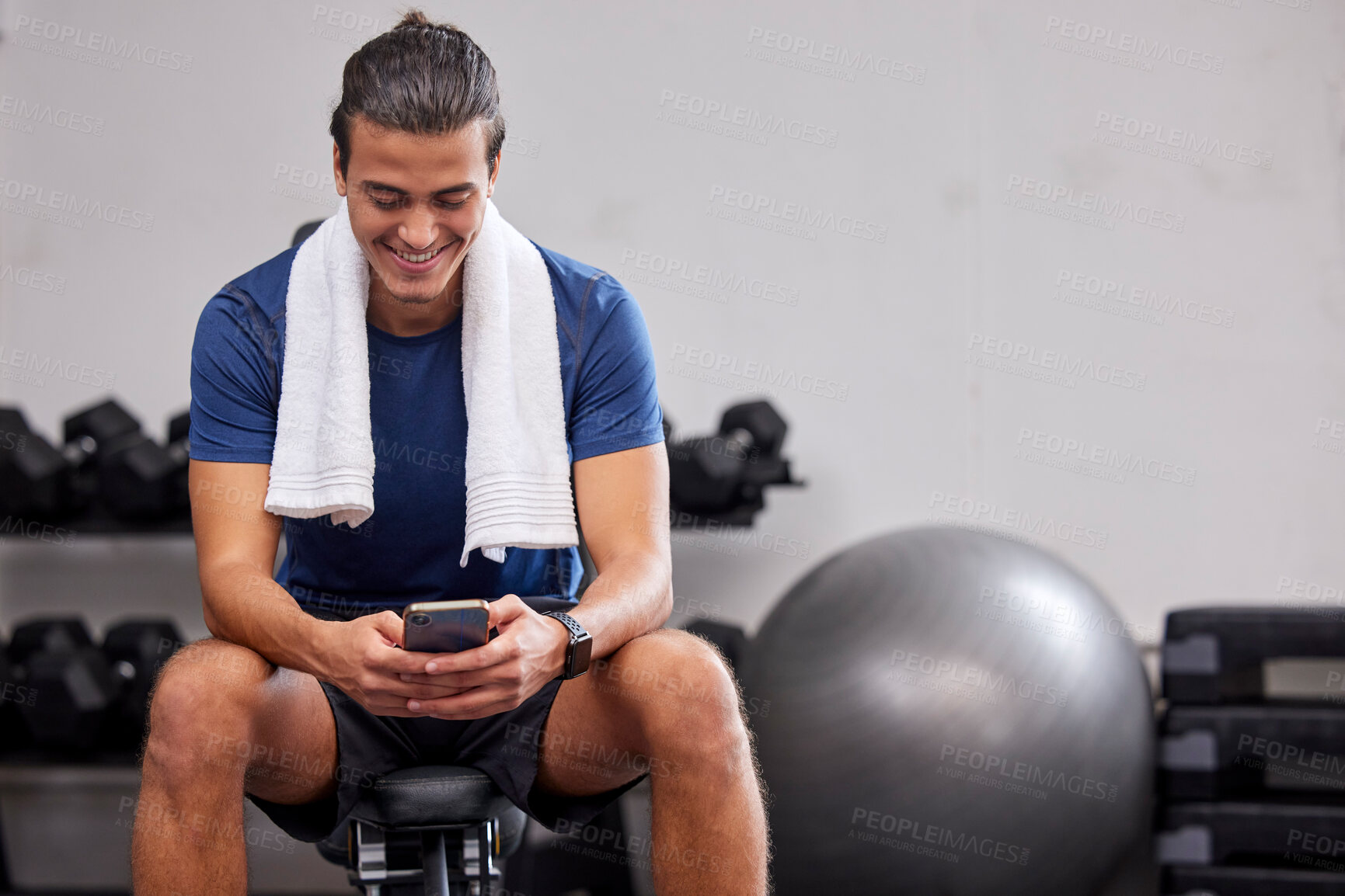 Buy stock photo Fitness, phone or man on social media to relax at gym in training, workout or exercise resting on a break. Tired, happy or healthy sports athlete typing text on a bench and exercising for body goals