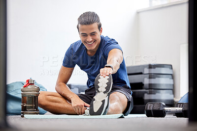 Buy stock photo Fitness, gym or man stretching legs starting training, workout or exercise warm up to relax muscles. Wellness, flexible or healthy sports athlete with a happy smile exercising in a studio in Brazil