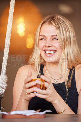 Buy stock photo Happy, young and woman at cafe with coffee in cup and cheerful smile enjoying break at table. Laugh, youth and happiness of girl customer with drink at casual restaurant with bokeh light.