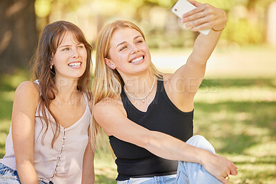 Buy stock photo Selfie, social media and park with a woman friends posing for a picture while sitting on the grass together during summer. Happy, smile and friendship with a female and her friend taking a photograph