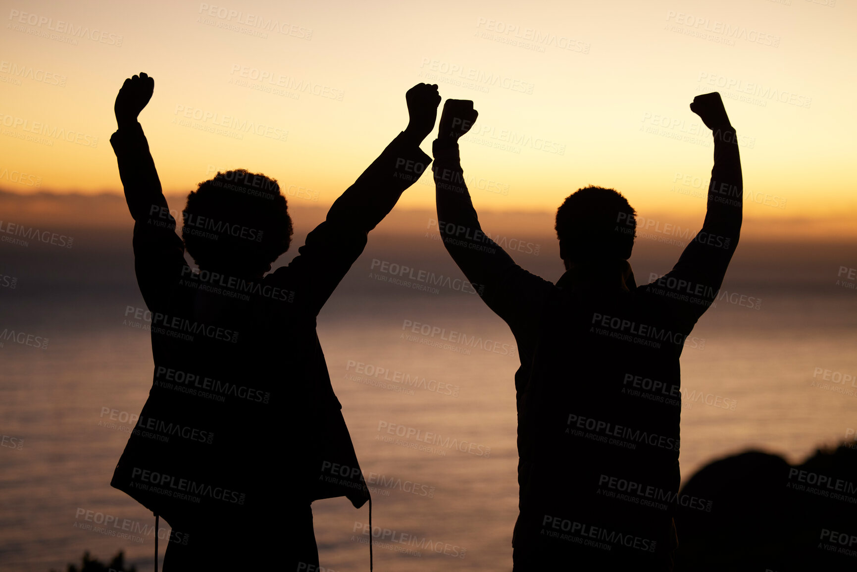 Buy stock photo Sunset, celebration and silhouette of couple at beach enjoying freedom, wellness and adventure outdoors. Victory, success and man with woman celebrate fitness goals, exercise and training achievement