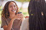 Woman, friends and laugh with coffee for chat or catch up on social life, friendship or relationship at an outdoor cafe. Happy female laughing in happiness for chatting, conversation or funny joke