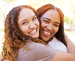 Young women and friends hug portrait for togetherness at park for bonding, wellness and happiness. Gen z, youth and natural black people with happy smile and embrace on summer hangout in nature.

