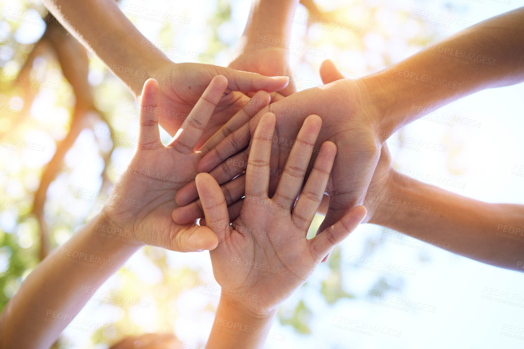 Buy stock photo Hands, community and group in unity for trust, support or teamwork goals piling together below for collaboration in nature. Hand of people in solidarity, union or coordination for united team effort