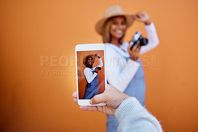 Buy stock photo Friends taking picture on a phone of woman isolated on wall background on social media or digital memory. Hand holding smartphone screen for happy profile of gen z, influencer person in summer mockup
