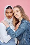 LGBTQ, love and lesbian couple with embrace of sexuality isolated on a pink background. Freedom, hug and diversity in a relationship with women hugging for affection, romance and a date on a backdrop