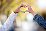 Heart sign with hands, love and couple outdoor, commitment and care in relationship, trust and support. People with connection, wellness and team together in nature, emoji or icon with partnership