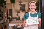 Woman, pottery and small business with open sign for creative startup, welcome or entrepreneurship at retail store. Portrait of happy shop owner with smile by entrance ready for service at the door