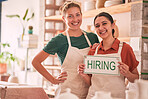 Portrait, hiring and sign with woman friends in a small business pottery workshop for recruitment. Startup, management or owner with a female entrepreneur and friend holding a notice in their studio