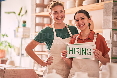 Buy stock photo Portrait, hiring and sign with woman friends in a small business pottery workshop for recruitment. Startup, management or owner with a female entrepreneur and friend holding a notice in their studio