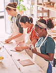 Pottery art and creative people row in workshop sculpting together for production process and productivity. Focus, concentration and skill of interracial team of women busy at  workspace.