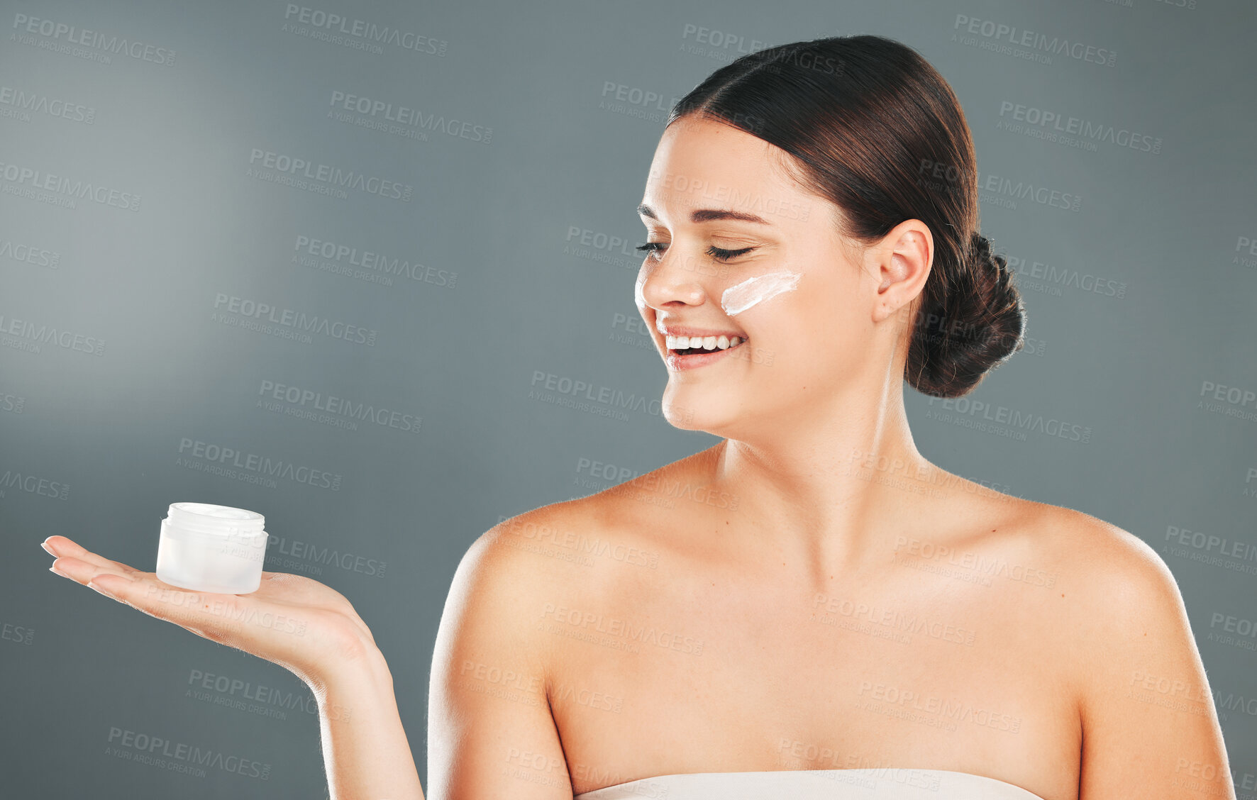 Buy stock photo Woman apply cream for face, happy with smile and beauty, skincare and moisturizer isolated on studio background. Sunscreen, lotion and healthy skin with glow, wellness and facial treatment product