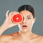 Skincare woman with grapefruit, health or confused face for wellness, aesthetic or facial product. Portrait of healthy, healthcare or nutrition with beauty, luxury and food in hand of model in studio