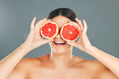 Buy stock photo Fruit eyes, woman and beauty model with grapefruit for skincare, wellness and health. Studio background, young person and happiness holding healthy food for vitamin c, diet and dermatology support