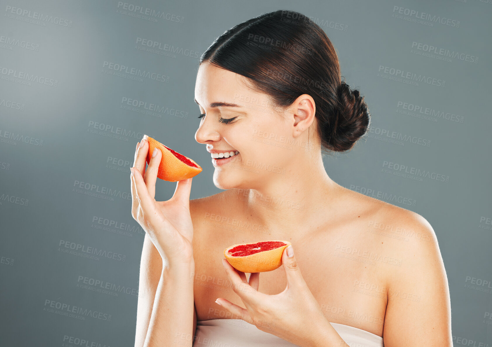 Buy stock photo Grapefruit, skincare woman or spa wellness for healthy diet, happy results or vitamin C on grey background. Beauty, smile or girl model face, facial makeup or aesthetic cosmetics for health in studio