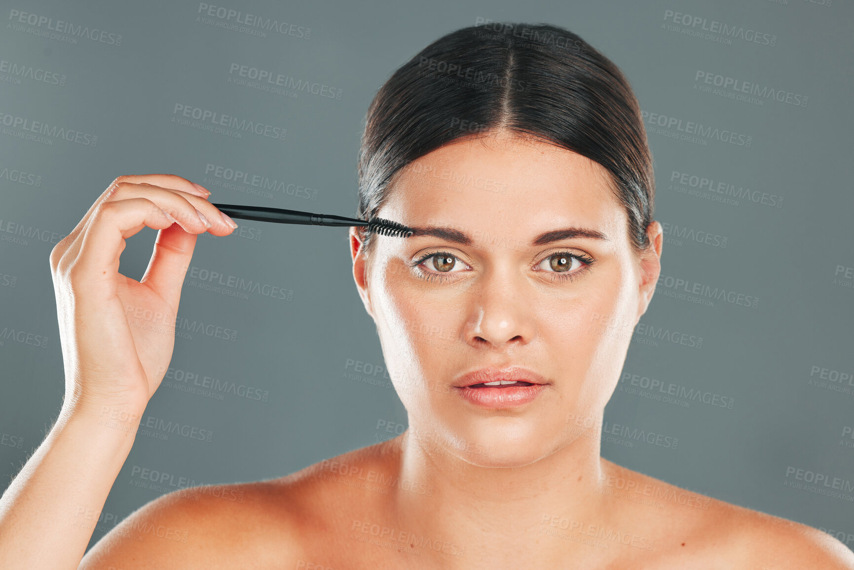 Buy stock photo Eyebrow skincare, brush and portrait of woman in studio for headshot, beauty transformation and cosmetics. Face, makeup and brushing brows with facial tool, model and hair on eyes for clean aesthetic