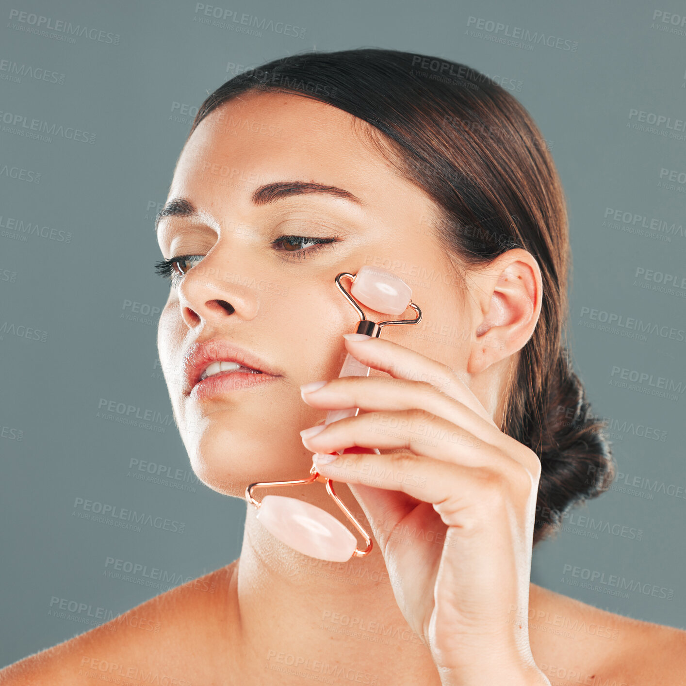 Buy stock photo Face massage closeup with roller, woman and skincare, beauty and healthy skin isolated on studio background. Natural cosmetics, glow and rose quartz makeup tools in hand, manicure and cosmetic care